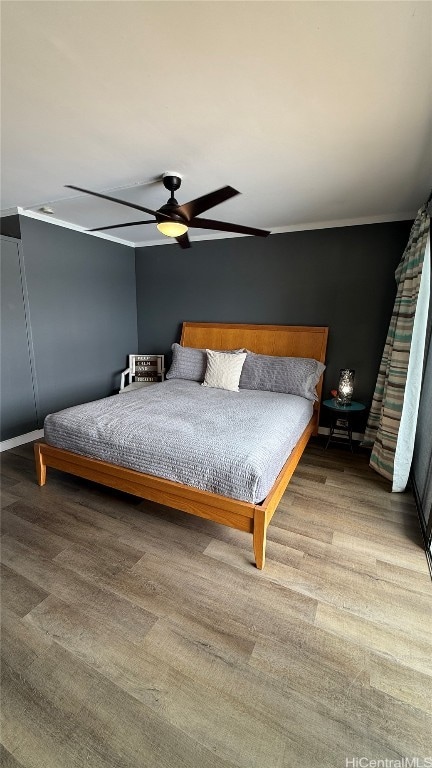 bedroom with hardwood / wood-style floors and ceiling fan