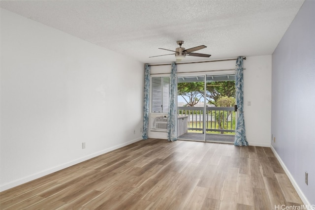 unfurnished room featuring a textured ceiling, light wood-type flooring, and ceiling fan