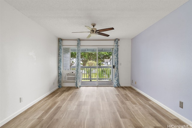 spare room with light hardwood / wood-style floors, a textured ceiling, and ceiling fan