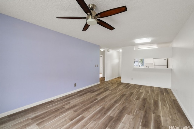 unfurnished room featuring hardwood / wood-style floors, a textured ceiling, and ceiling fan