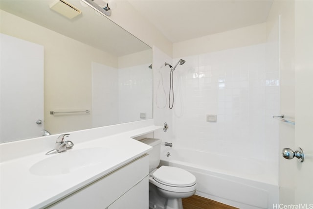 full bathroom featuring vanity, toilet, hardwood / wood-style flooring, and tiled shower / bath