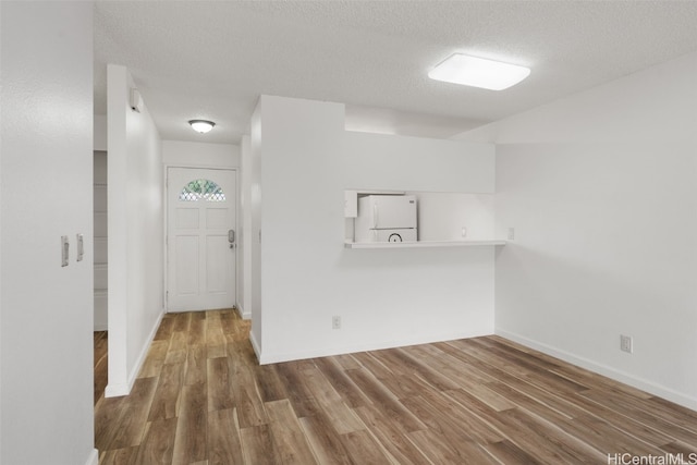 spare room with hardwood / wood-style floors and a textured ceiling