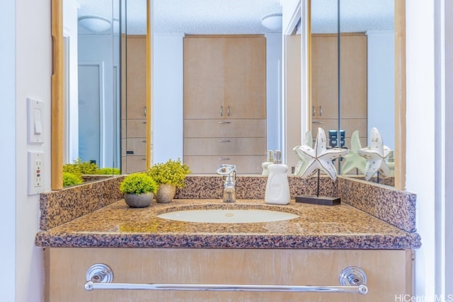 bathroom featuring vanity and a textured ceiling