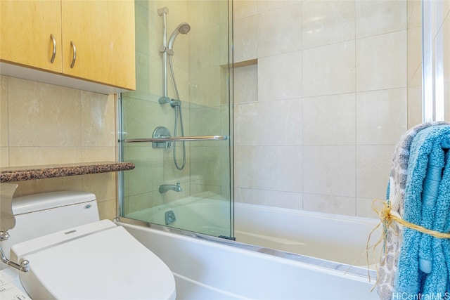 bathroom with toilet and enclosed tub / shower combo