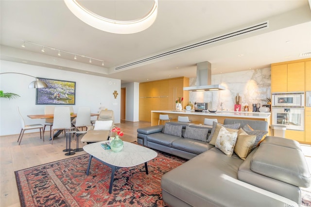 888 Kapiolani Blvd Unit Ph4507, Honolulu, HI 96813 - living room featuring light wood-style flooring and rail lighting