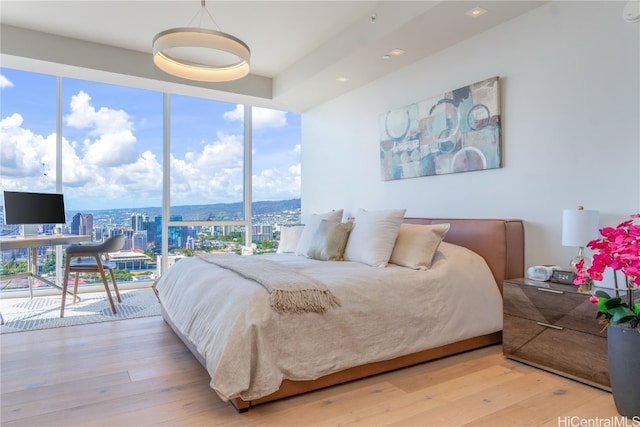 bedroom featuring light wood-type flooring and access to outside