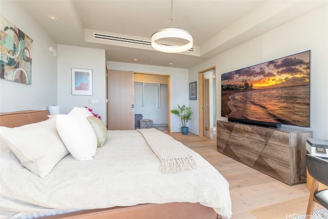 bedroom with light wood-type flooring and a closet