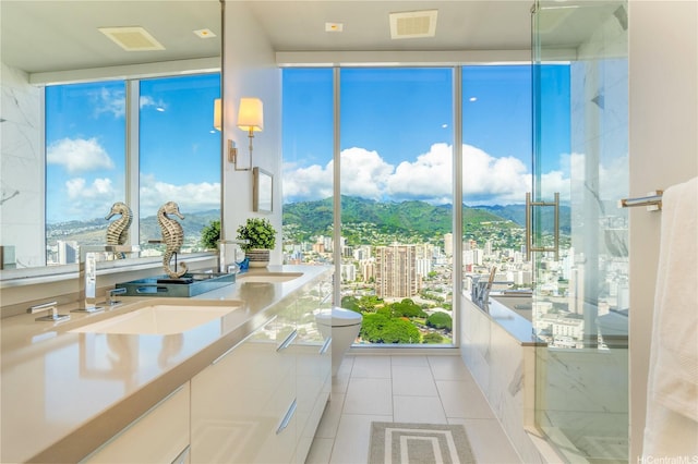 888 Kapiolani Blvd Unit Ph4507, Honolulu, HI 96813 - full bathroom with a city view, tile patterned flooring, toilet, and double vanity