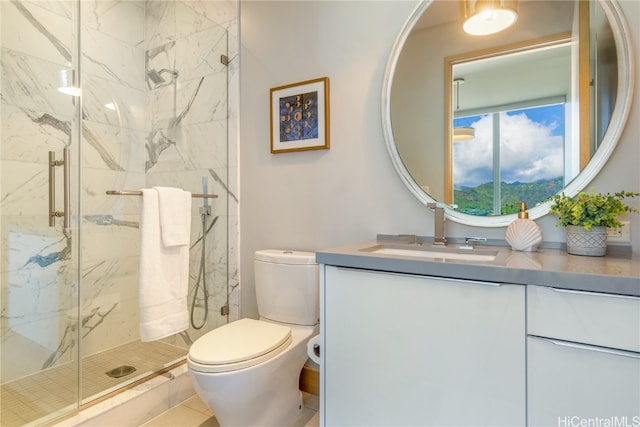 bathroom with a shower with shower door, vanity, toilet, and tile patterned floors