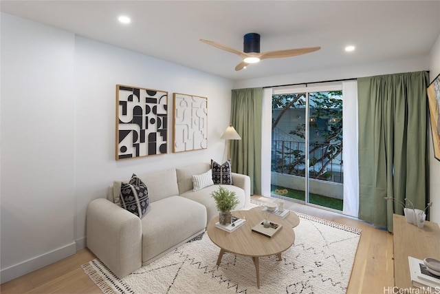 living room featuring ceiling fan and light wood-type flooring