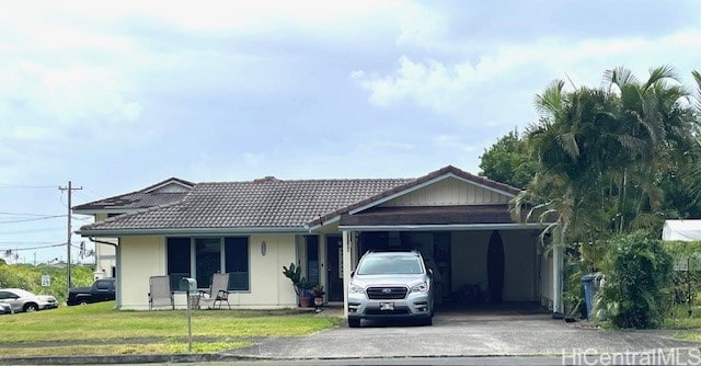 view of front of house with a front yard and a carport