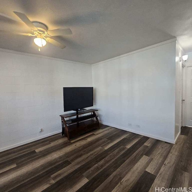 interior space with a textured ceiling, ceiling fan, ornamental molding, and dark wood-type flooring