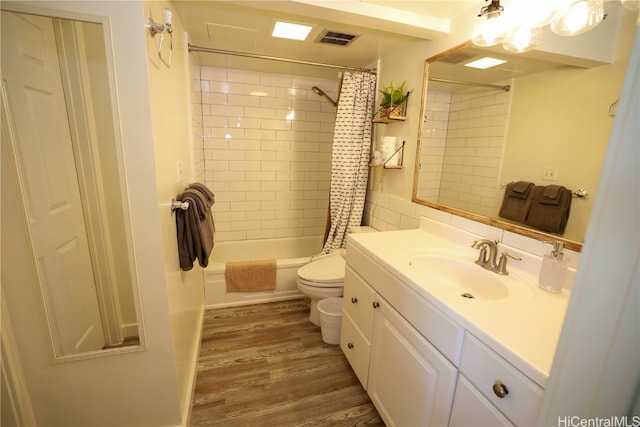 full bathroom featuring wood-type flooring, vanity, toilet, and shower / bath combo