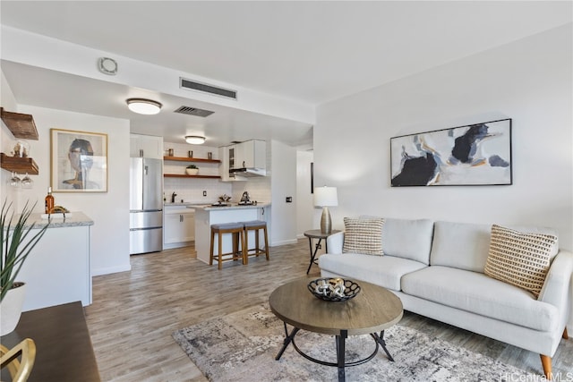 living room with light hardwood / wood-style floors