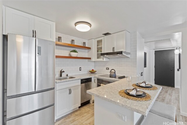 kitchen with white cabinetry, light wood-type flooring, stainless steel appliances, and sink