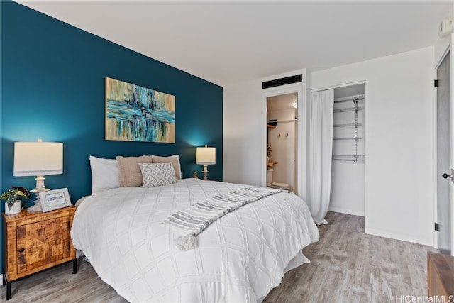 bedroom with hardwood / wood-style flooring and a closet