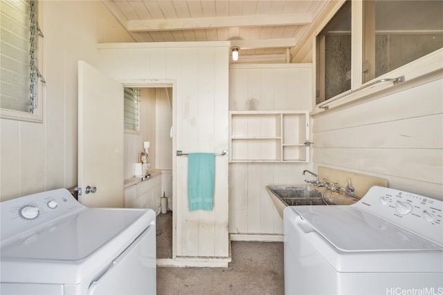 clothes washing area with wood walls, wood ceiling, sink, and carpet flooring