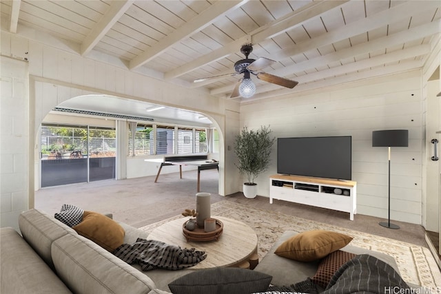 living room with carpet flooring, plenty of natural light, ceiling fan, and beam ceiling