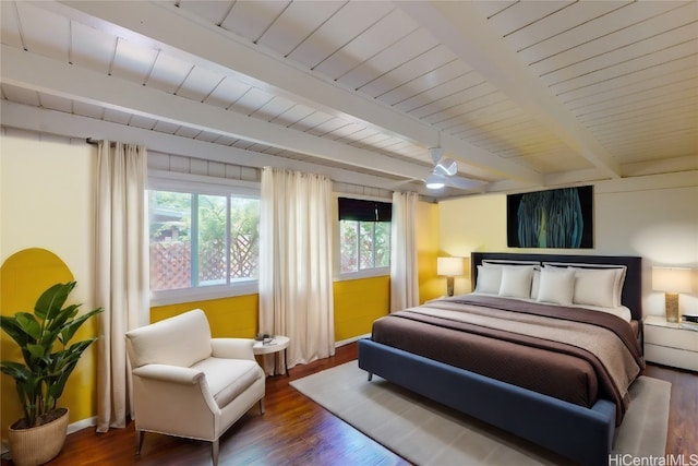 bedroom with dark wood-type flooring, ceiling fan, and beam ceiling