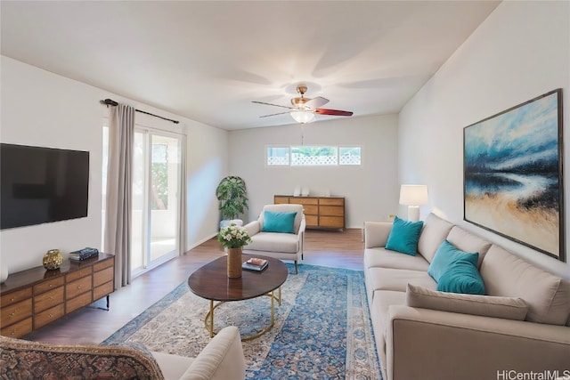 living room featuring a wealth of natural light, wood-type flooring, lofted ceiling, and ceiling fan