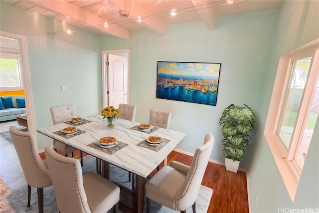 dining room with hardwood / wood-style floors, beamed ceiling, and wood ceiling