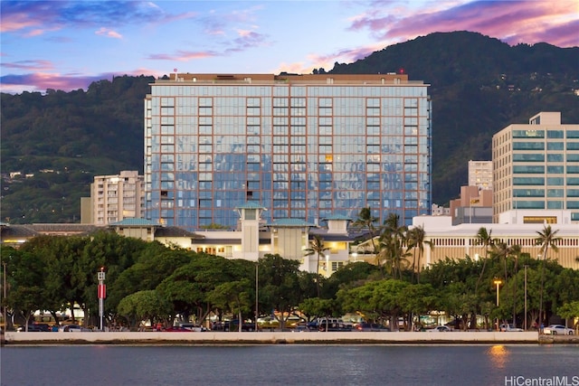 outdoor building at dusk with a water and mountain view