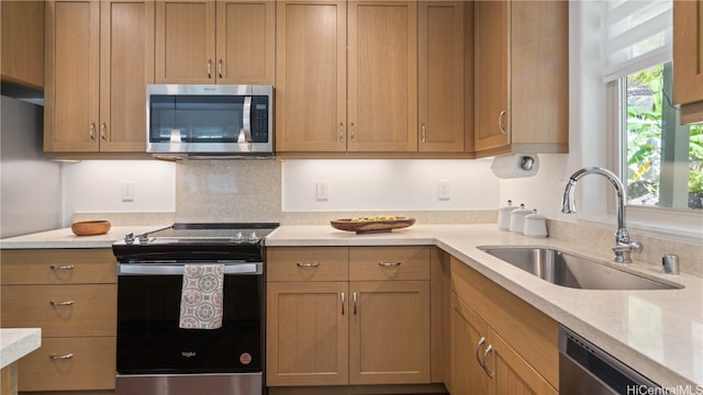 kitchen featuring sink, backsplash, and appliances with stainless steel finishes