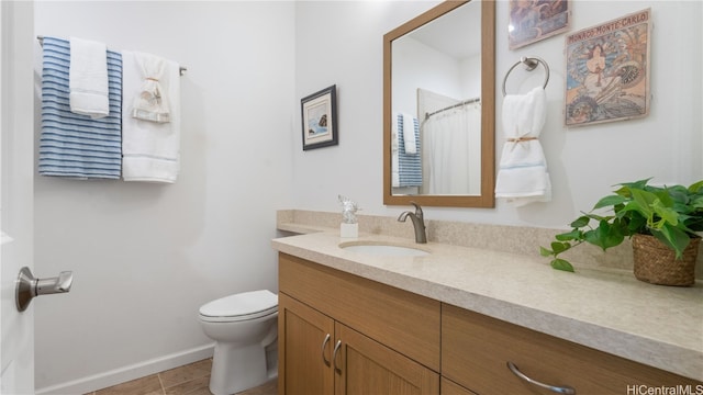 bathroom featuring curtained shower, tile patterned floors, vanity, and toilet