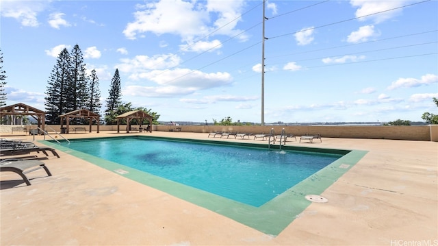 view of swimming pool with a patio and a gazebo