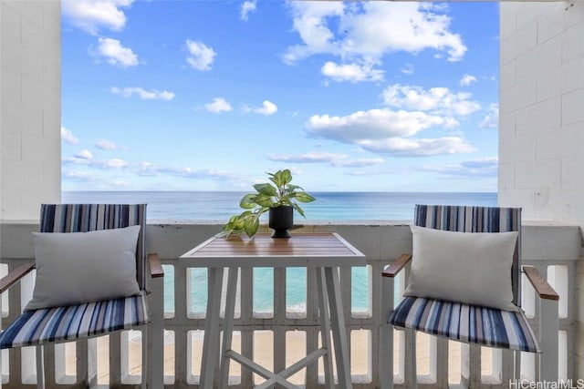 balcony featuring a water view and a view of the beach