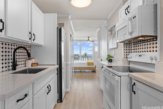 kitchen featuring tasteful backsplash, sink, white appliances, white cabinetry, and ornamental molding