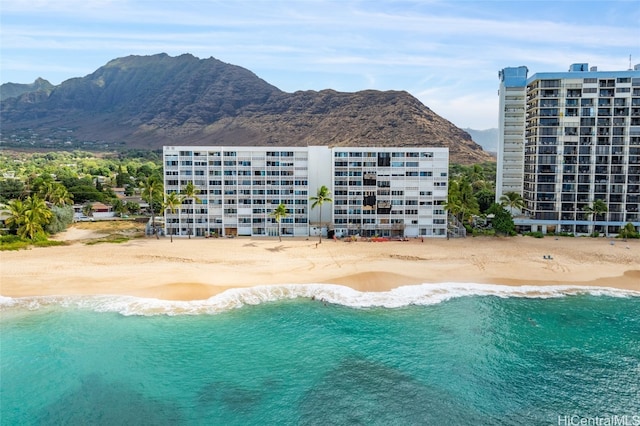 view of pool with a water and mountain view and a view of the beach