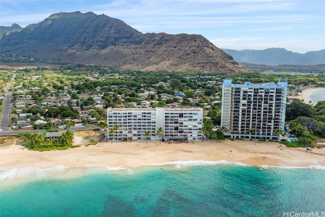 exterior space featuring a water and mountain view and a view of the beach