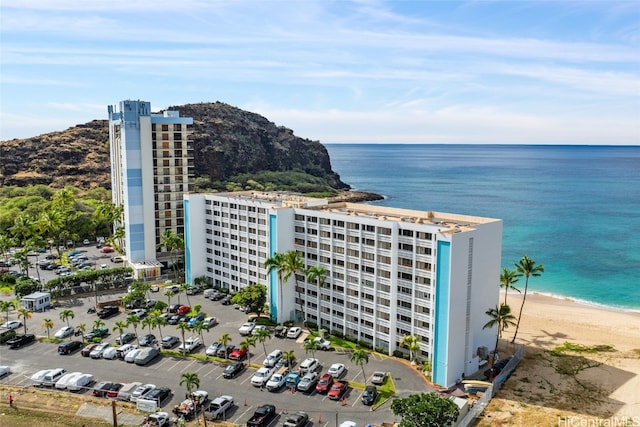 drone / aerial view with a beach view and a water view