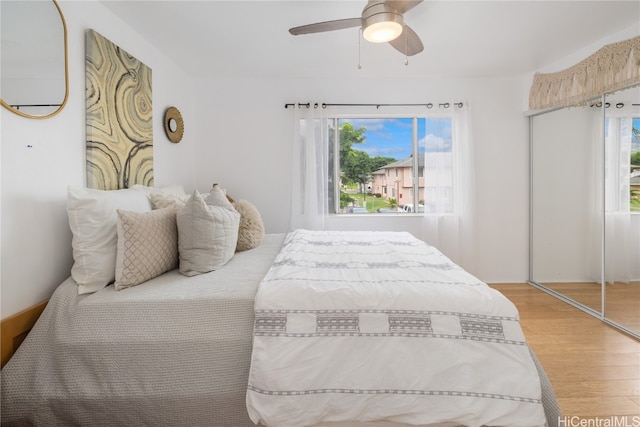 bedroom featuring hardwood / wood-style floors, a closet, and ceiling fan