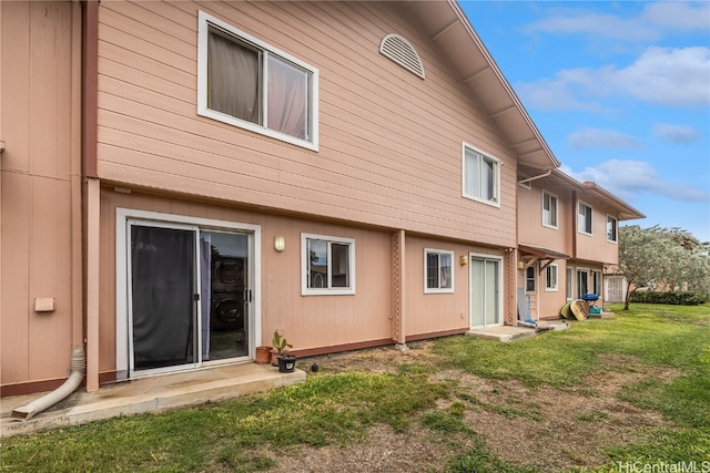 rear view of property featuring a yard