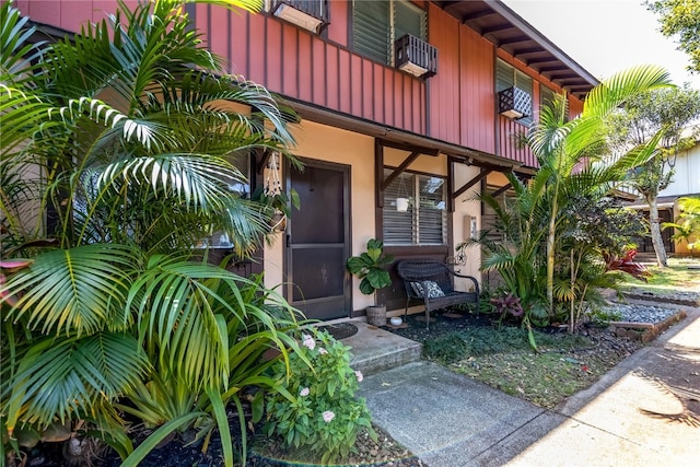 view of exterior entry featuring a balcony