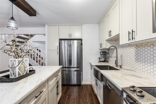 kitchen featuring sink, stainless steel appliances, dark hardwood / wood-style flooring, pendant lighting, and white cabinets