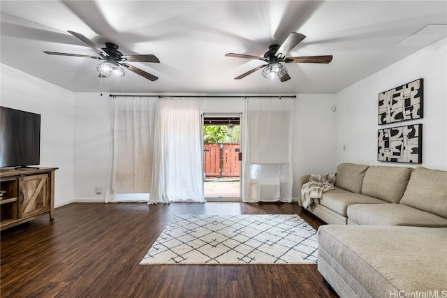 living room featuring ceiling fan and dark hardwood / wood-style flooring