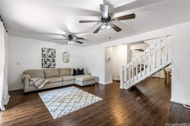 living room featuring ceiling fan and dark hardwood / wood-style floors