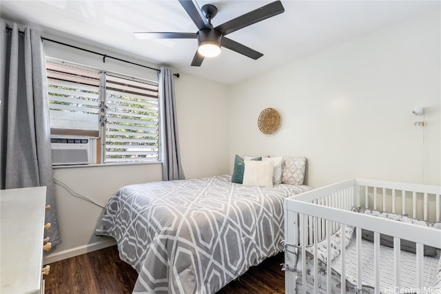 bedroom featuring dark hardwood / wood-style flooring, ceiling fan, and cooling unit