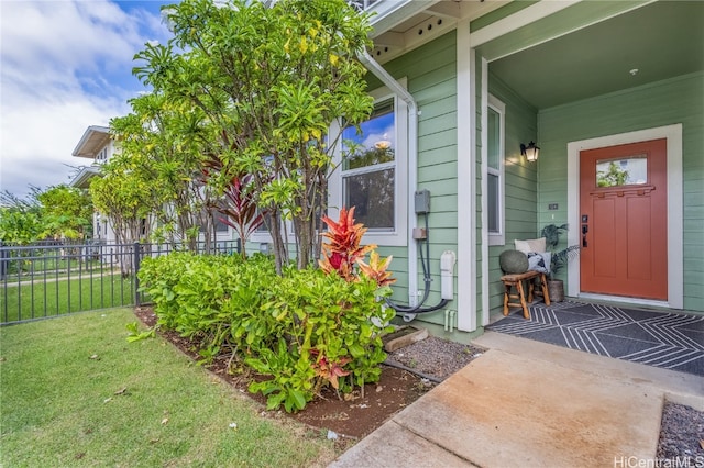 entrance to property with a lawn