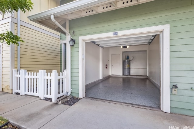 garage featuring strapped water heater and a garage door opener