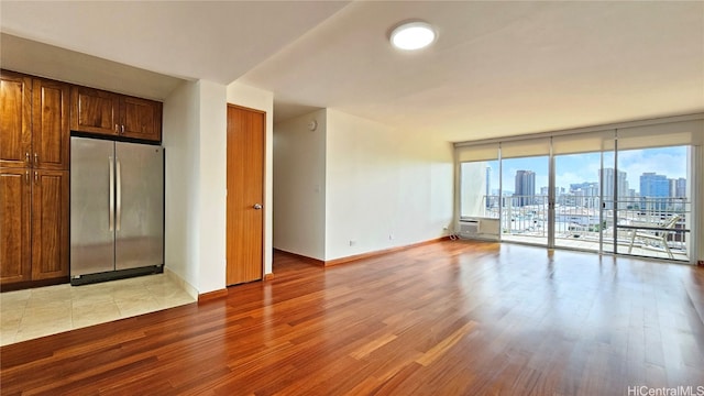 interior space with a wall of windows and light hardwood / wood-style flooring