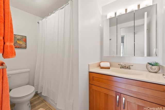 bathroom with hardwood / wood-style floors, vanity, toilet, and a shower with curtain