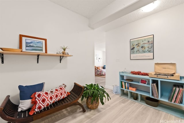 sitting room with wood-type flooring and a textured ceiling