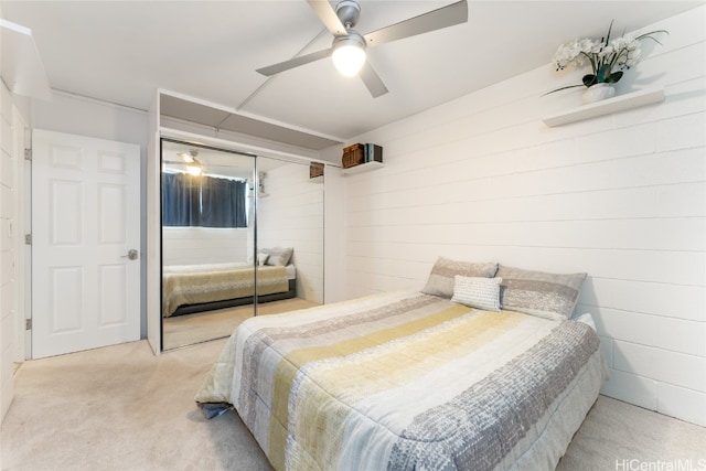 bedroom with light carpet, ceiling fan, and a closet