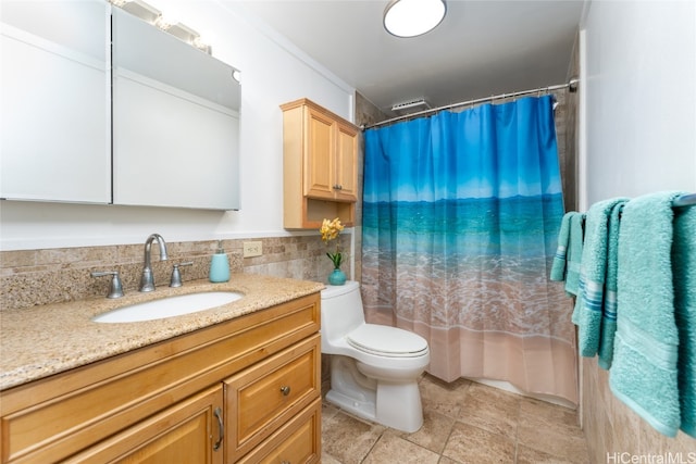 bathroom featuring toilet, tasteful backsplash, and vanity