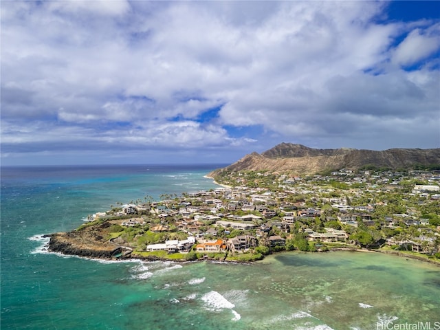 drone / aerial view featuring a water and mountain view