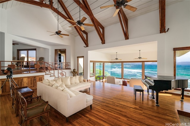 living room with beam ceiling, high vaulted ceiling, and wood-type flooring